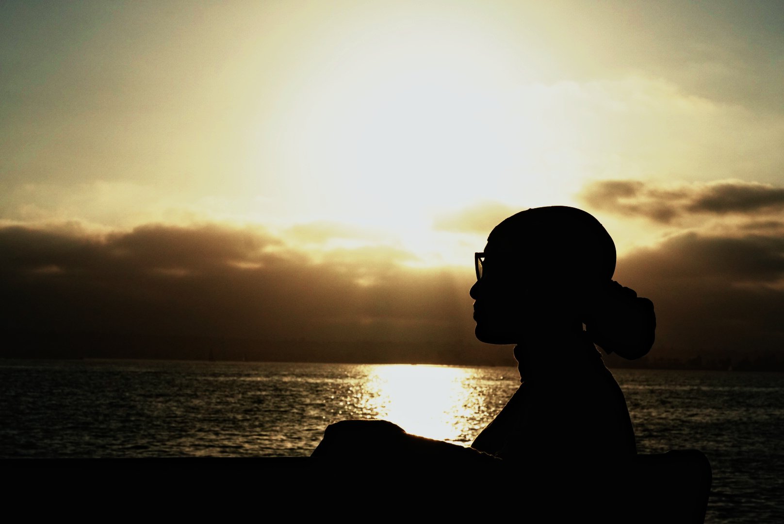 Silhouetted profile against a golden ocean sunset — wedding photography by Wayne Anderson